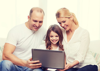 Image showing parents and little girl with laptop at home