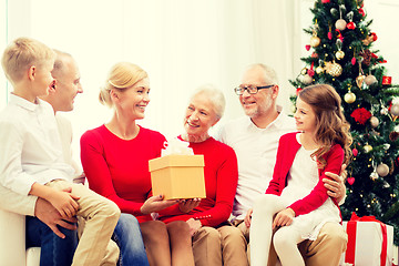 Image showing smiling family with gifts at home