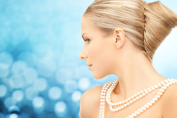 Image showing beautiful woman with sea pearl necklace over blue