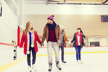 Image showing happy friends on skating rink