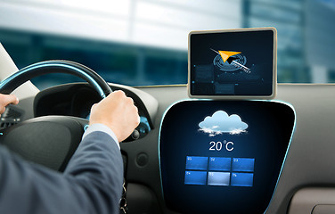 Image showing close up of businessman with tablet pc driving car