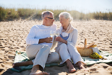 Image showing happy senior couple talking on summer beach