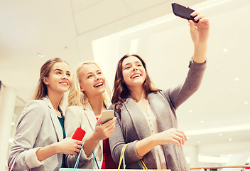 Image showing women with smartphones shopping and taking selfie