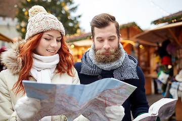 Image showing happy couple with map and city guide in old town