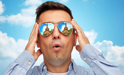Image showing face of man in sunglasses looking at eiffel tower