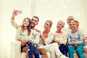 Image showing happy family taking selfie with smartphone at home