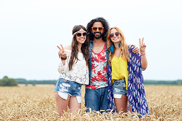 Image showing happy young hippie friends showing peace outdoors