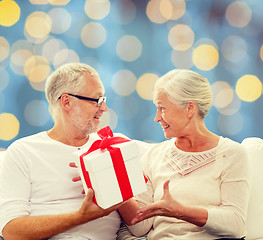 Image showing happy senior couple with gift box