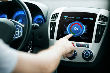 Image showing hand setting volume on car audio stereo system