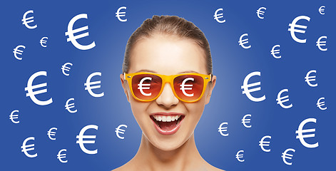 Image showing happy woman in shades with euro currency sings