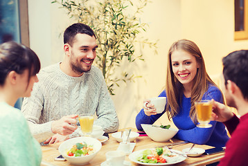 Image showing happy friends meeting and having dinner at cafe