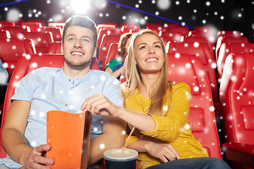 Image showing happy couple with popcorn and drink in cinema