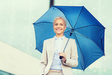 Image showing young smiling businesswoman with umbrella outdoors