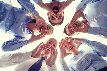 Image showing smiling group of businesspeople standing in circle