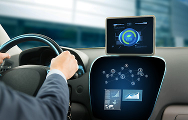 Image showing close up of man with tablet pc driving car