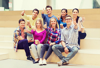 Image showing group of smiling students with paper coffee cups