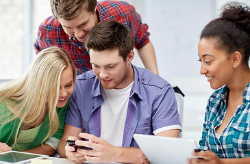 Image showing group of happy students with smartphone at school