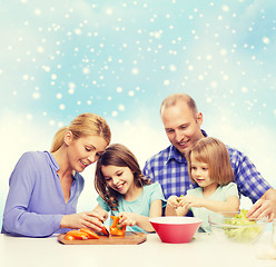 Image showing happy family with two kids making dinner at home