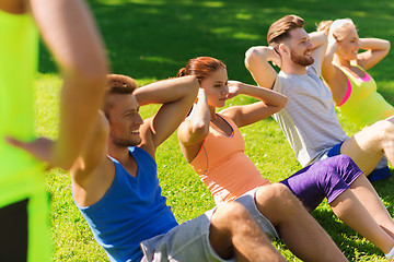 Image showing group of friends or sportsmen exercising outdoors