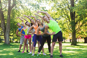 Image showing group of friends or sportsmen exercising outdoors