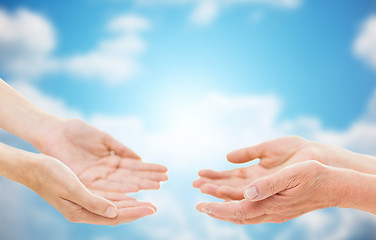 Image showing close up of senior and young woman hands