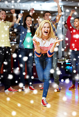 Image showing happy young woman throwing ball in bowling club