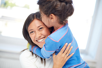 Image showing happy mother and daughter hugging at home