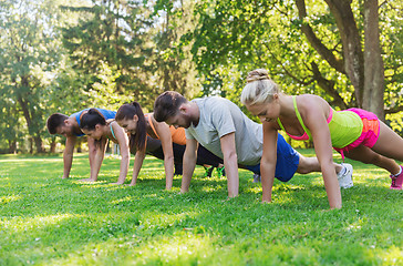 Image showing group of friends or sportsmen exercising outdoors