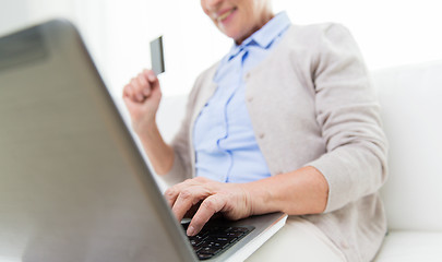 Image showing senior woman with laptop and credit card at home