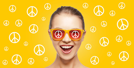 Image showing happy teenage hippy girl in shades with peace sign