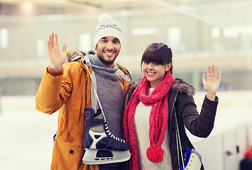 Image showing happy couple with ice-skates on skating rink