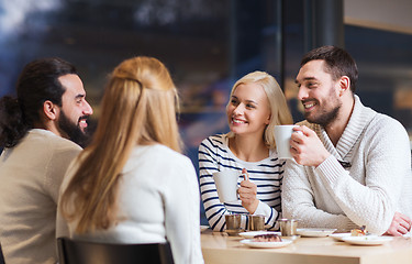 Image showing happy friends meeting and drinking tea or coffee