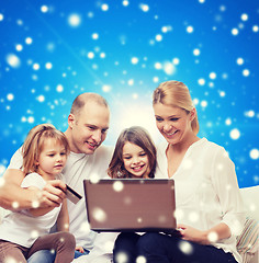 Image showing happy family with laptop computer and credit card