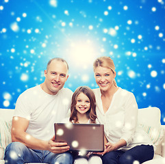 Image showing smiling family with laptop