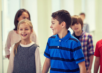 Image showing group of smiling school kids walking in corridor