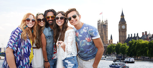 Image showing happy hippie friends with selfie stick at coliseum