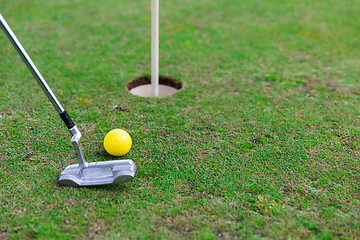 Image showing close up of club and ball near hole on golf field