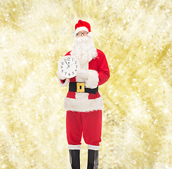 Image showing man in costume of santa claus with clock