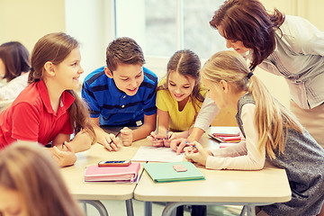 Image showing group of school kids writing test in classroom