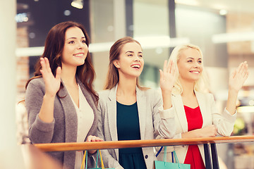 Image showing happy young women with shopping bags in mall