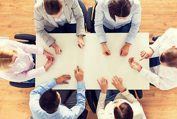 Image showing close up of business team sitting at table