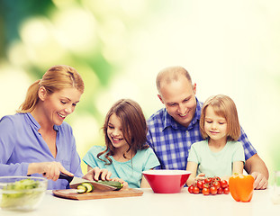 Image showing happy family with two kids making dinner at home