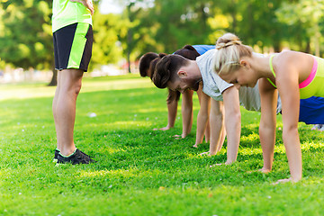 Image showing group of friends or sportsmen exercising outdoors