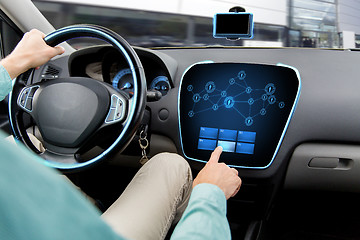 Image showing close up of man driving car with on board computer