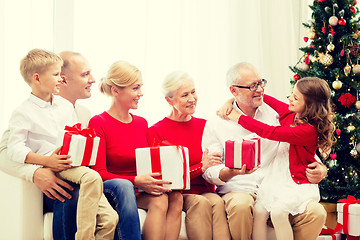 Image showing smiling family with gifts at home