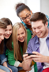 Image showing group of happy students with smartphone at school