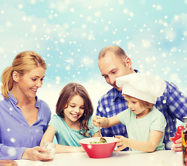 Image showing happy family with two kids making salad at home