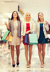 Image showing happy young women with shopping bags in mall