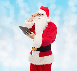 Image showing man in costume of santa claus with tablet pc