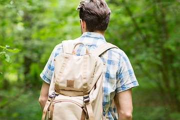 Image showing young man with backpack hiking in woods
